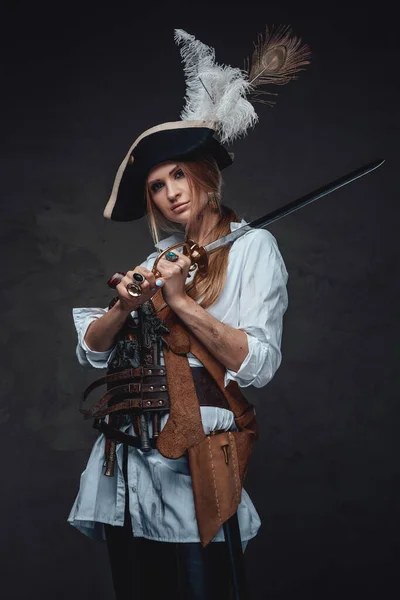 Studio shot of woman corsair with saber and guns — Stock Photo, Image