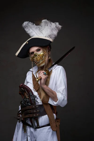 Woman pirate with golden mask and saber — Stock Photo, Image