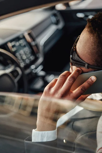 Black business man talking on his phone inside of car — Stock Photo, Image