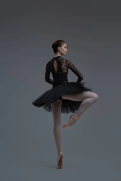 Rear view of ballerina wearing dress dancing inside studio — Stock Photo, Image