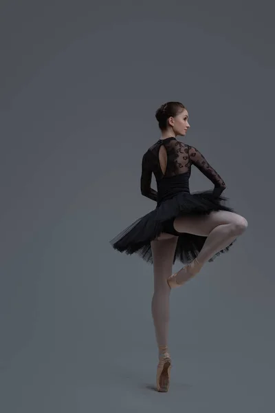 Rear view of ballerina wearing dress dancing inside studio — Stock Photo, Image