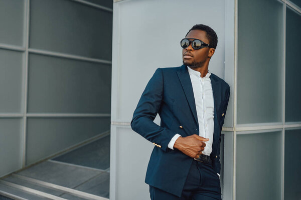 Fashionable african business man posing around building