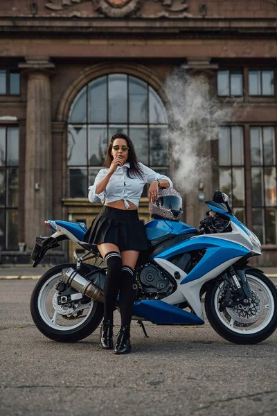 Stylish girl with vape and motorbike outside on road — Stock Photo, Image