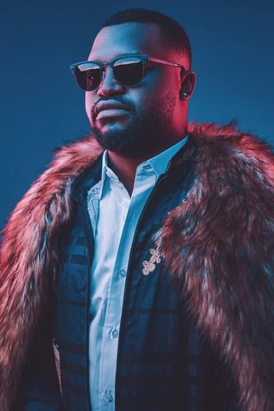 Confident african man dressed in fur and suit — Stock Photo, Image