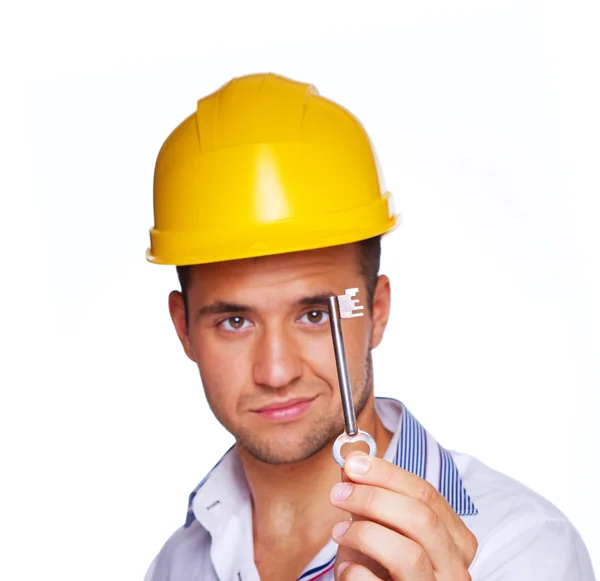 Portrait of sexy worker posing in studio with key — Stock Photo, Image