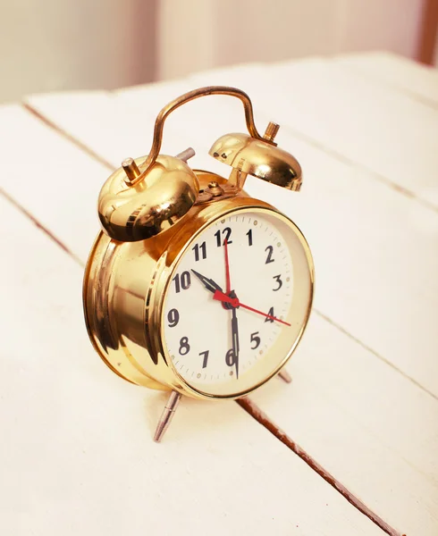 Old fashioned gold watch on the wooden table — Stock Photo, Image