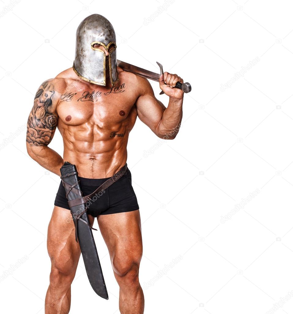 Hot warrior in helmet is holding sword in his shoulder