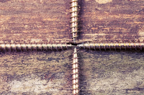 Four screws pointing at each other — Stock Photo, Image