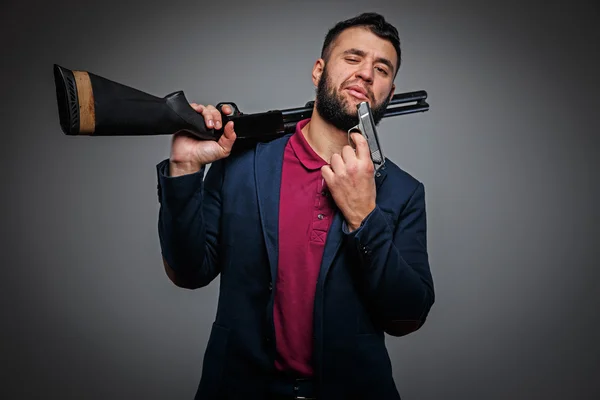 Powerful businessman with a gun — Stock Photo, Image
