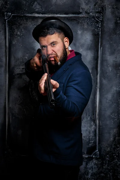 Powerful businessman with a gun — Stock Photo, Image