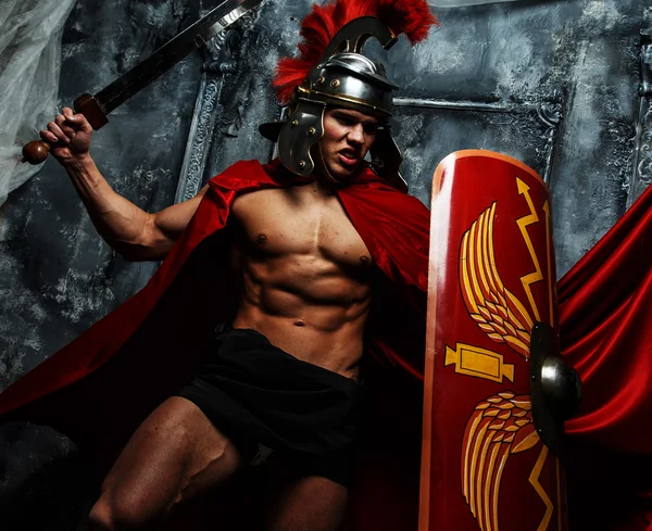 Muscular Roman posing on grey background. — Stock Photo, Image