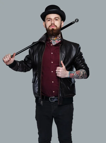 Tattoed gangster holding cane — Stock Photo, Image