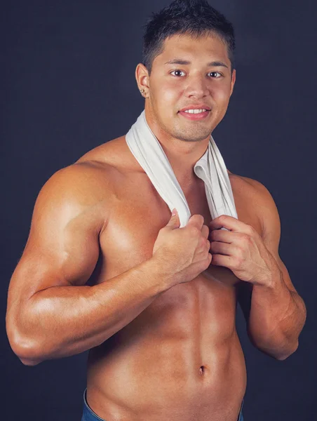 Sportsman holding shirt on neck — Stock Photo, Image