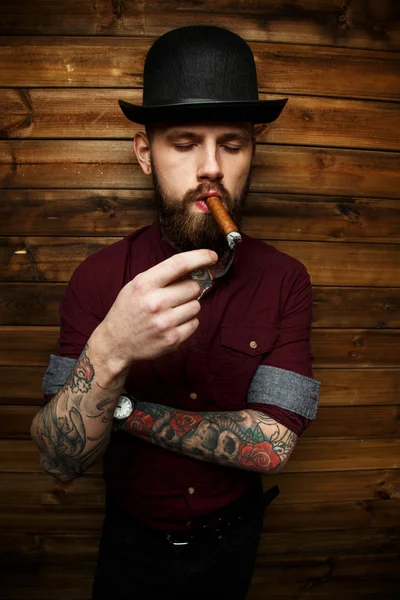 Brutal tattooed male with cigar — Stock Photo, Image