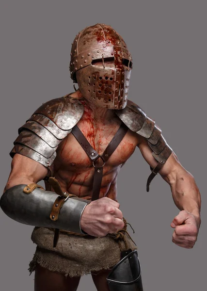 Wounded gladiator with muscular body in armour — Stock Photo, Image