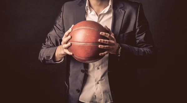 Mature businessman holding basketball ball — Stock Photo, Image