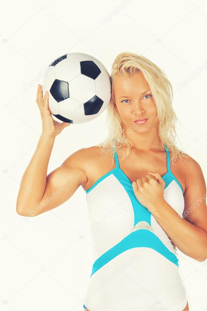 Image of lying woman with ball in studi