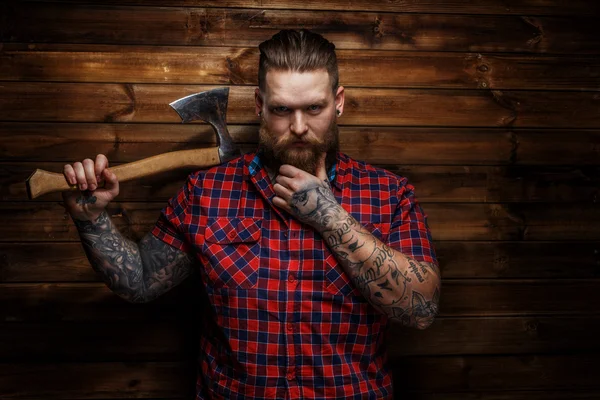 Strict brutal huge male with beard and axe — Stock Photo, Image