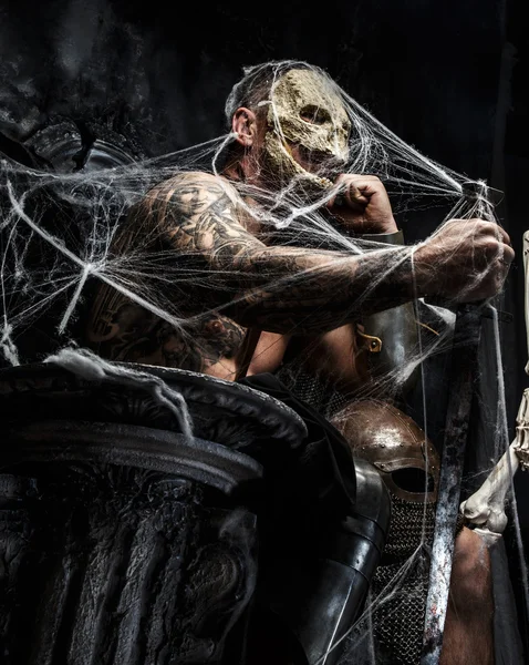 Muscular man with skull on his face. — Stock Photo, Image