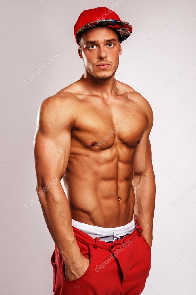 Muscular man in red cap.
