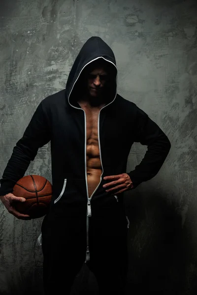 Man in black jacket with basketball — Stock Photo, Image