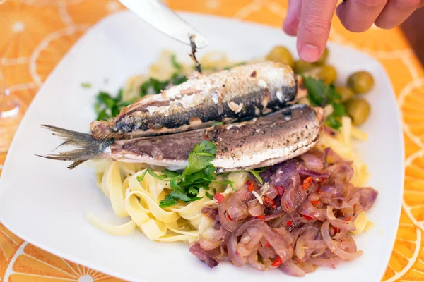 Peixe e macarrão em prato branco — Fotografia de Stock
