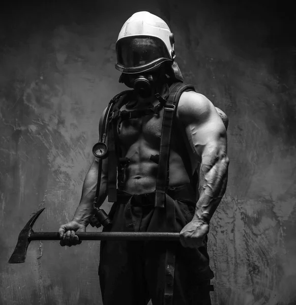 Muscular firefighter with axe — Stock Photo, Image