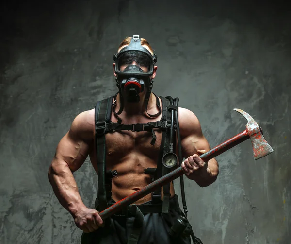 Muscular firefighter with axe — Stock Photo, Image