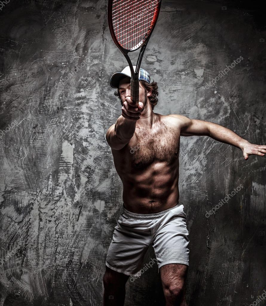 Male tennis player with racket. Stock Photo by ©fxquadro 68433691