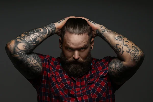 Male with tattoo on arms in studio — Stock Photo, Image