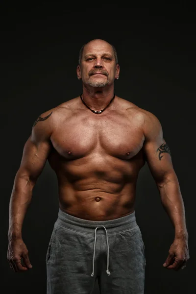 Muscolare uomo di mezza età mostrando i suoi muscoli — Foto Stock