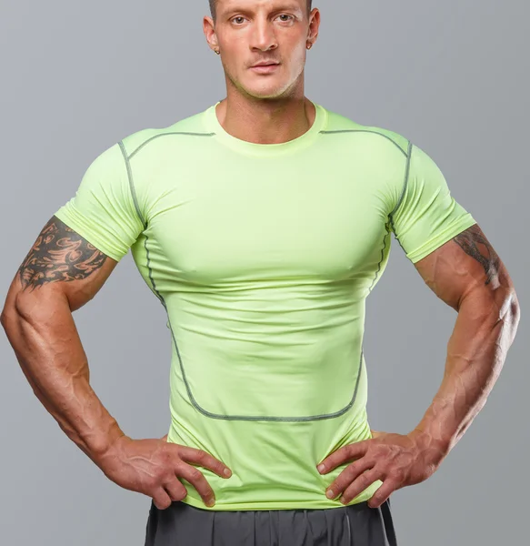 Awesome muscular man in green undershirt — Stock Photo, Image