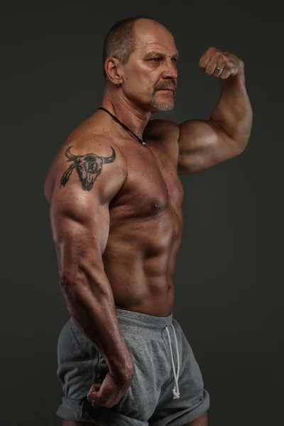 Muscular middle age man showing his muscules Royalty Free Stock Photos