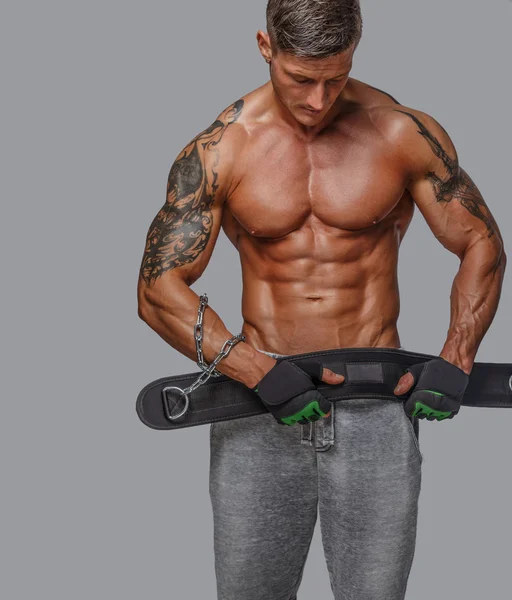 Muscular guy holding power waist — Stock Photo, Image