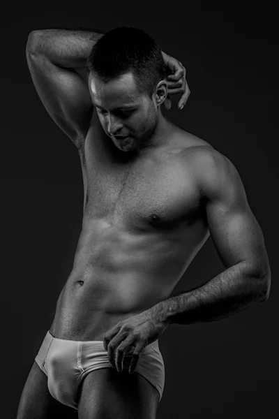 Man in panties posing on gray background — Stock Photo, Image