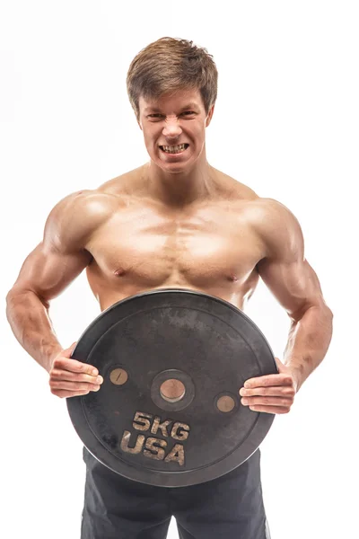 Awesome young bodybuilder holding weights — Stock Photo, Image