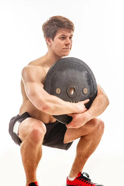 Awesome young bodybuilder holding weights — Stock Photo, Image