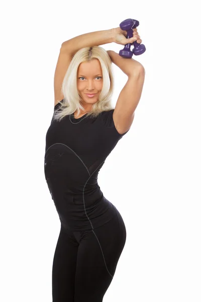 Szczupła blond kobieta w czarnej odzieży sportowej — Zdjęcie stockowe