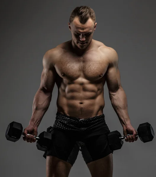 Awesome muscular guy with dumbell — Stock Photo, Image