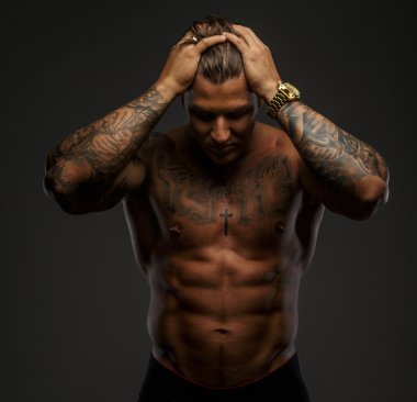 Muscular man with tattooes clipart