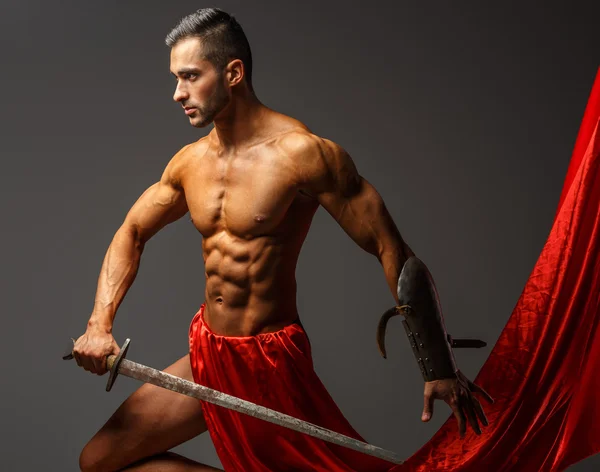 Shirtless guy holding sword — Stock Photo, Image