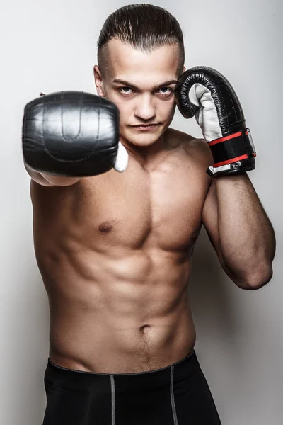 Muscular guy in boxing gloves — Stock Photo, Image