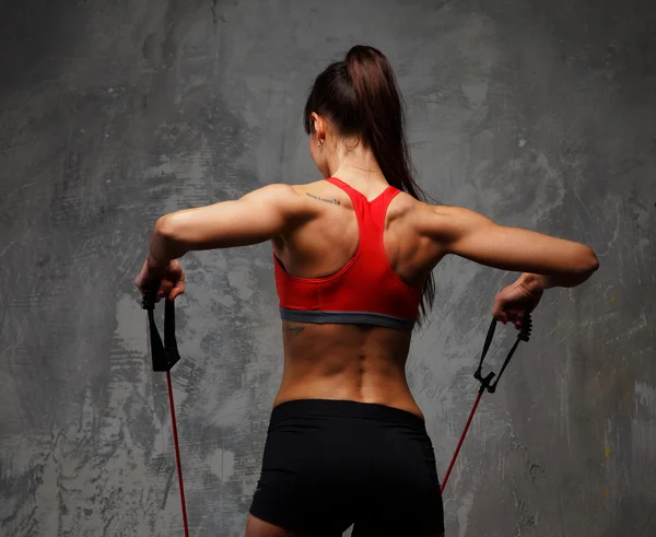 Woman doing exercises with expander. — Stock Photo, Image