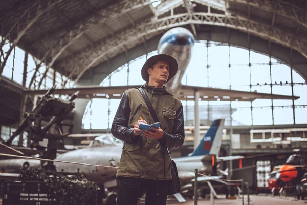 Funny man in airplanes museum. — Stock Photo, Image