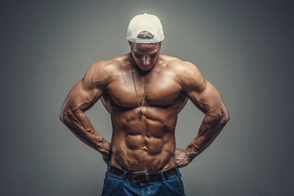 Shirtless muscular guy in blue jeans — Stock Photo, Image