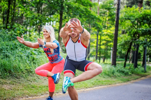 Man and woman doing exercises. — Stock Photo, Image