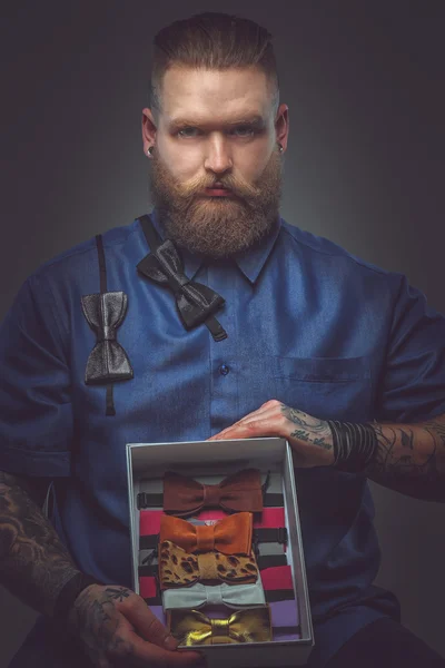 Man in blue shirt with bow ties collection. — Stock Photo, Image