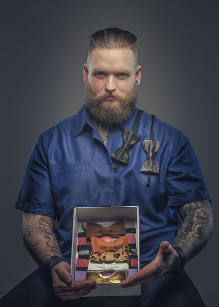 Man in blue shirt with bow ties collection.