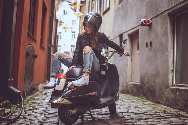 Casual girl sitting on scooter — 스톡 사진