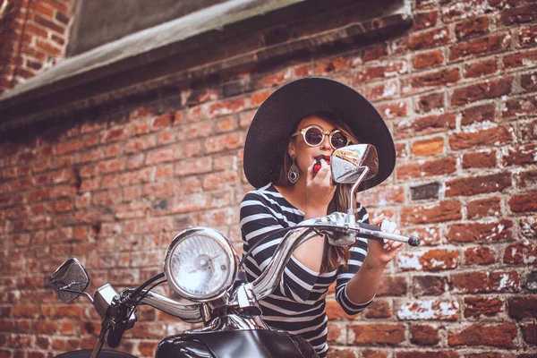 Fashin girl sitting on street scooter. — Stockfoto